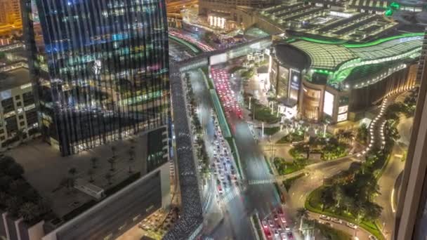 Aerial panorama of Downtown Dubai with shopping mall and traffic on a street night timelapse from above, UAE — Vídeo de Stock