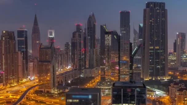 Panorama of Dubai Financial Center district with tall skyscrapers with illumination night to day timelapse. — 图库视频影像