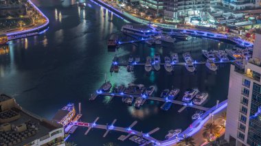 Birçok yat ve tekne limandaki hava sahasına park edilmiştir. Dubai Marina rıhtımı yürüyüş alanı. Modern tekne derede yüzüyor..