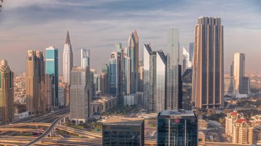 Dubai Finans Merkezi 'nin Panorama' sında uzun gökdelenler zaman ayarlı. Gün batımında yoğun karayolu boyunca kulelerin hava görüntüsü
