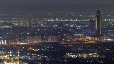 Deira 'da gökdelenleri olan Zabeel bölgesindeki villalar Dubai, BAE' de bir arka plan hava gece zaman çizelgesinde. Aydınlatılmış evleri ve yolları olan caddelerde trafik