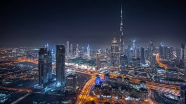 Panorama, Dubai şehir merkezindeki en yüksek kuleleri ve karayolu gece manzarasını gösteriyor. Finansal bölge ve şehir merkezindeki iş alanı. Gökdelen ve yüksek binalar