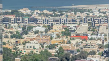 Birleşik Arap Emirlikleri 'nin finans bölgesindeki gökdelenden Dubai' deki apartman ve villaların hava görüntüsü. Palmiyeler ve ağaçlarla çevrili bir bölge