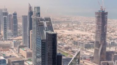Şehir merkezinin ufuk çizgisi, modern mimari biçimli, zaman çizgisinin üstünde. Dubai iş hangarı kulelerinin hava görüntüsü. Su kanalları ve villalar üzerindeki köprü