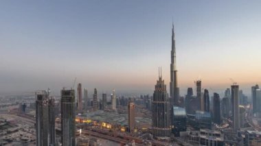 Dubai şehir merkezindeki en yüksek kulelerin havadan görünüşü ufuk ve dere bölgesinin gündüz ve gece geçiş zamanı. Finansal bölge ve şehir merkezindeki iş alanı. Gökdelen ve yüksek binalar