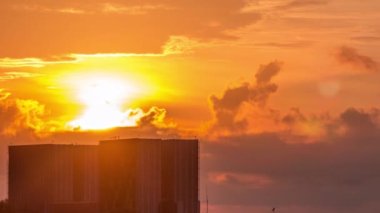 Beautiful sunrise at Marina Barrage timelapse close up view. Orange sky and clouds with sun beams. It is Singapores 15th reservoir and the first in the heart of the city.
