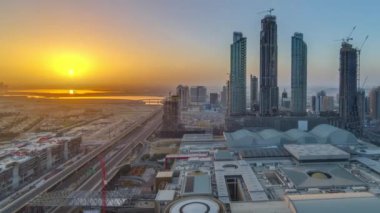 Dubai downtown gündoğumu timelapse modern gökdelenler, alışveriş merkezi ve sabah yolda trafik ile. Üstten üstten görünüm