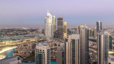 Dubai gece geçiş timelapse, çeşmeler ile ışıklı lüks modern binalar, Birleşik Arap Emirlikleri fütüristik cityscape downtown gün. Güneş battıktan sonra gökdelen üzerinden hava üstten görünüm
