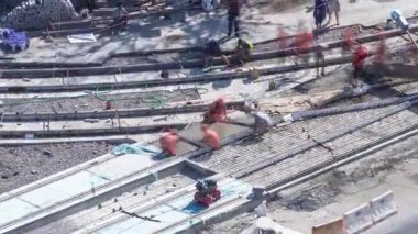 Birçok işçi ve karıştırıcı zaman ayarlı beton ya da yol onarım inşaatı. Havadan görünüşlü. Kavşaktaki tramvay raylarının yeniden inşası