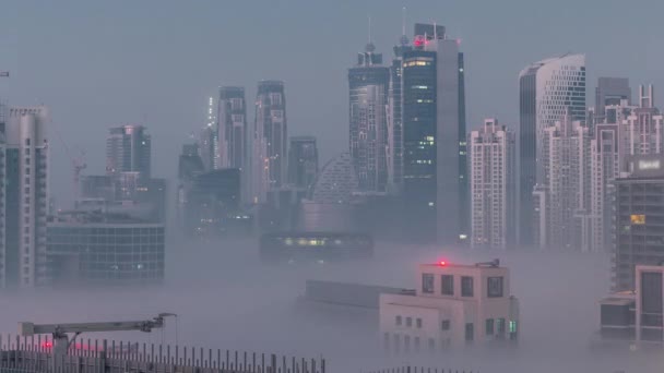 ビジネスベイ地区の夜から昼への移行時間経過で朝霧とドバイの高層ビル アラブ首長国連邦のダウンタウンの上からの空中ビュー — ストック動画