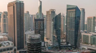 Dubai Marina Skyline 'ın arka planında JLT gökdelenleri var. Güneş doğarken cam yüzeyi ve yatları olan kuleler.