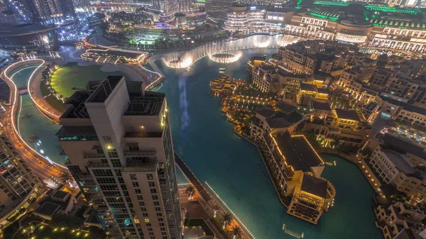 Aerial view to Old Town Island from above night timelapse. Dubai downtown with fountains area near mall and souk. Look down perspective