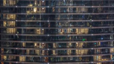 Gece vakti üst sınıf bir binanın pencerelerinin önünde oturuyorlardı. Gökdelende parlayan sarı ışıklar