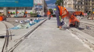 Tram rails at the final stage of their installation and integration into concrete plates on the road panoramic timelapse. Filling by liquid resin for reduction of vibration and noice. The process of