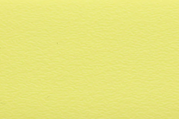 Texture of yellow PVC plastic for edging chipboard ends. Decorative yellow background texture.