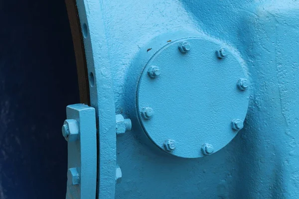A large, old valve on a city water pipe. 