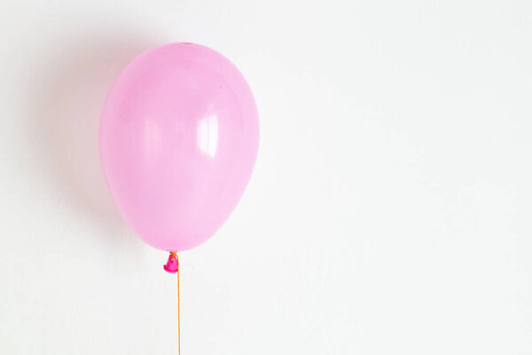 Pink balloon. Pink festive, joyful balloon on a string. 