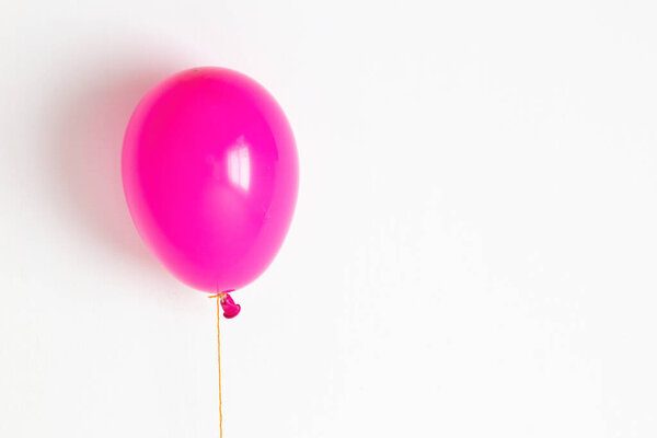 Pink balloon. Pink festive, joyful balloon on a string. 