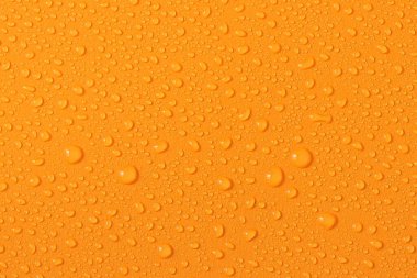 Water droplets on a colored texture. Decorative texture with water drops.