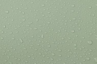 Water droplets on a colored texture. Decorative texture with water drops.