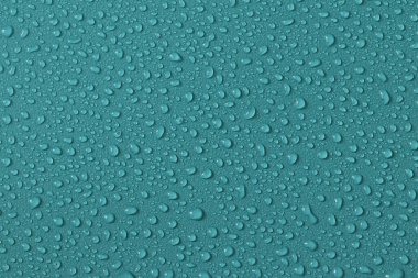 Water droplets on a colored texture. Decorative texture with water drops.