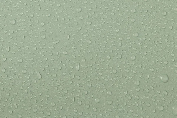 Water droplets on a colored texture. Decorative texture with water drops.