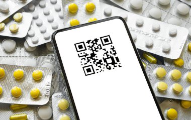 smartphone with qr code on the background of tablets