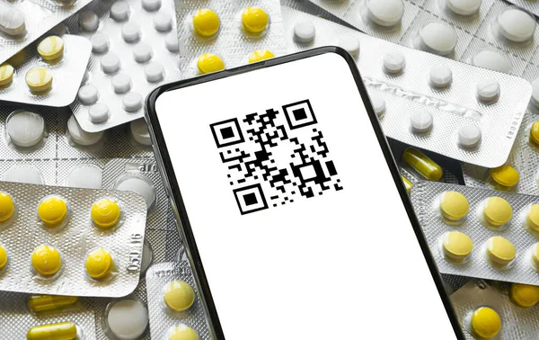 Smartfon z kodem QR na tle tabletek Obrazek Stockowy