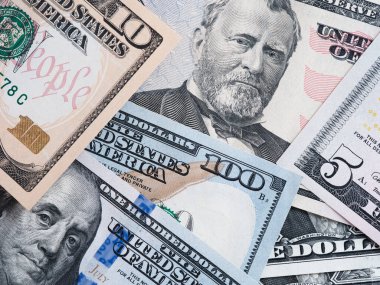 American dollar bills in a pile. Close up.