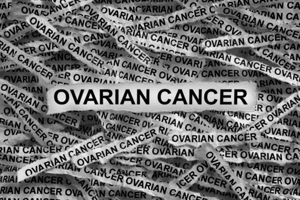 Strips of newspaper with the words Ovarian Cancer. Black and white. Close up.