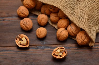 broken walnuts and nuts in a bag close-up, selective focus