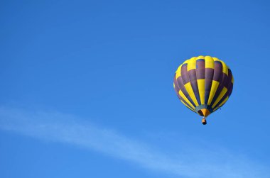 beautiful yellow blue hot air balloon against the blue sky, copy space, place for text