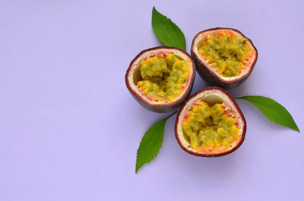 appetizing passion fruit in a cut on a purple background, copy space