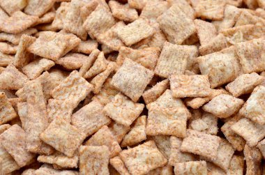 many whole grain cereal cinnamon pads food background