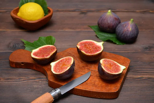 cut figs on a cutting board on the table