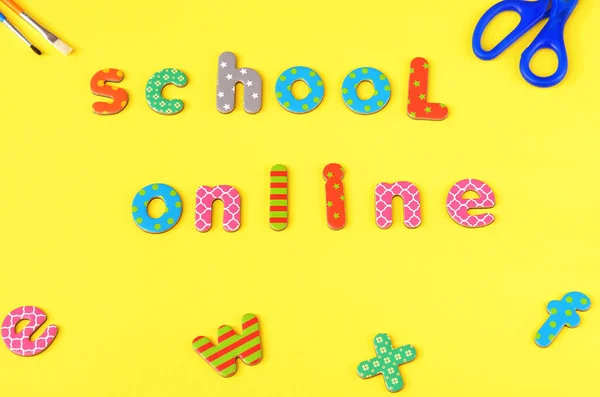 the inscription school online on a yellow background