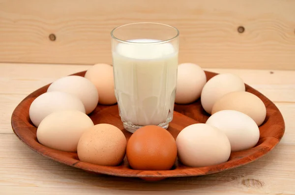 white and yellow eggs with glass of milk, close up