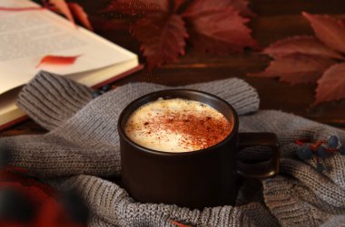 cinnamon is poured into a cappuccino cup clipart