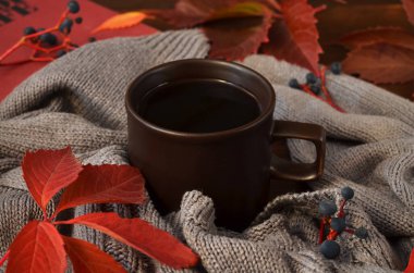 a cup of coffee and autumn leaves clipart