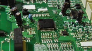 İşlemcinin cımbız ve lehimleme istasyonuyla kurulumunun makro videosu. Mikroçipin altında kızarıklık var. Duman çıkıyor. Elektronik, bilgisayar, TV tamirhanesi