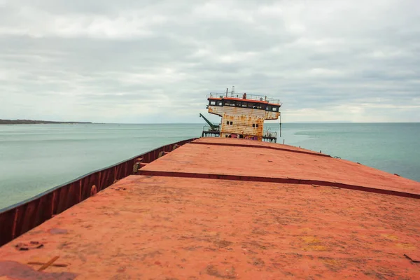 View from the ship\'s side of the captain\'s cabin. A dry cargo ship abandoned after a shipwreck