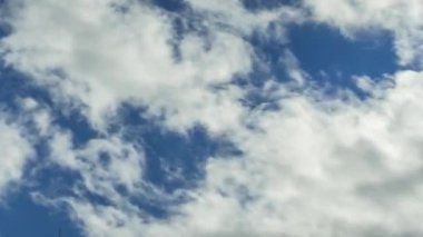 Mavi gökyüzünde hızlı uçan beyaz bulutların zamanı.