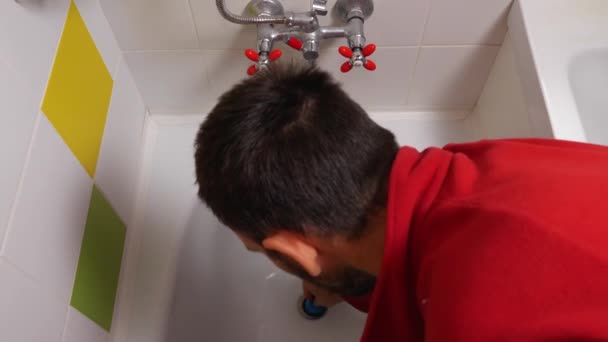 View Man Red Sweater Plugging Drain Bathtub Turns Faucet Valve — Stock Video