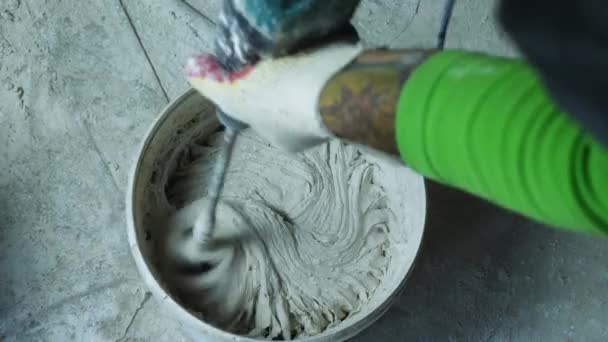 Top View Man Hand Electric Hand Mixer Stirring Plaster Bucket — Stock videók
