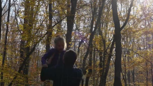 Man Tosses Girl Standing Autumn Forest Close Father Daughter Park — Stockvideo