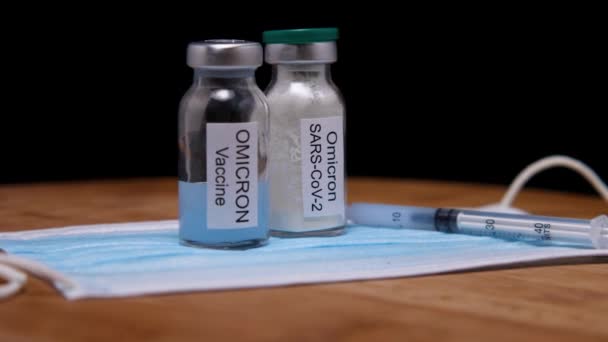 Two Vials Omicron Vaccine Syringe Medical Mask Wooden Background Camera — ストック動画