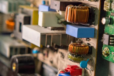 The dusty board of a modern television. Close-up, selective focus. Electronics repair shop