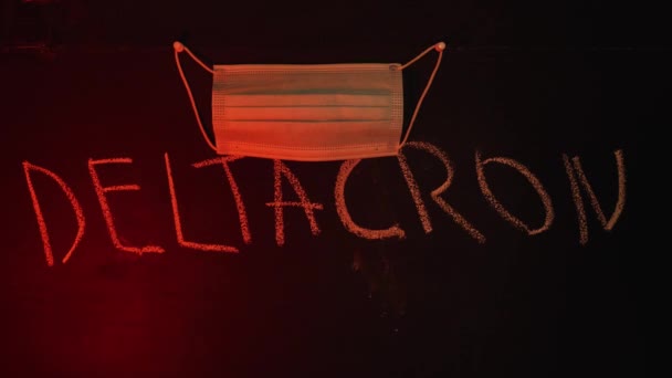 Medical Mask Hangs Pushpin Board Chalked Deltacron Dark Red Background — стокове відео