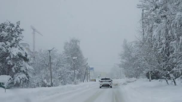 Auto Rijden Een Besneeuwde Weg Stad Tijdens Een Sneeuwstorm Uitzicht — Stockvideo