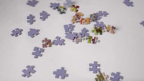 Slow Motion Puzzle Pieces Fall Haphazardly White Background Forming Pile — Stock Video